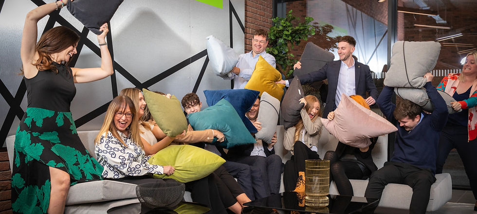 The Lucent team enjoying a cushion fight at the office!