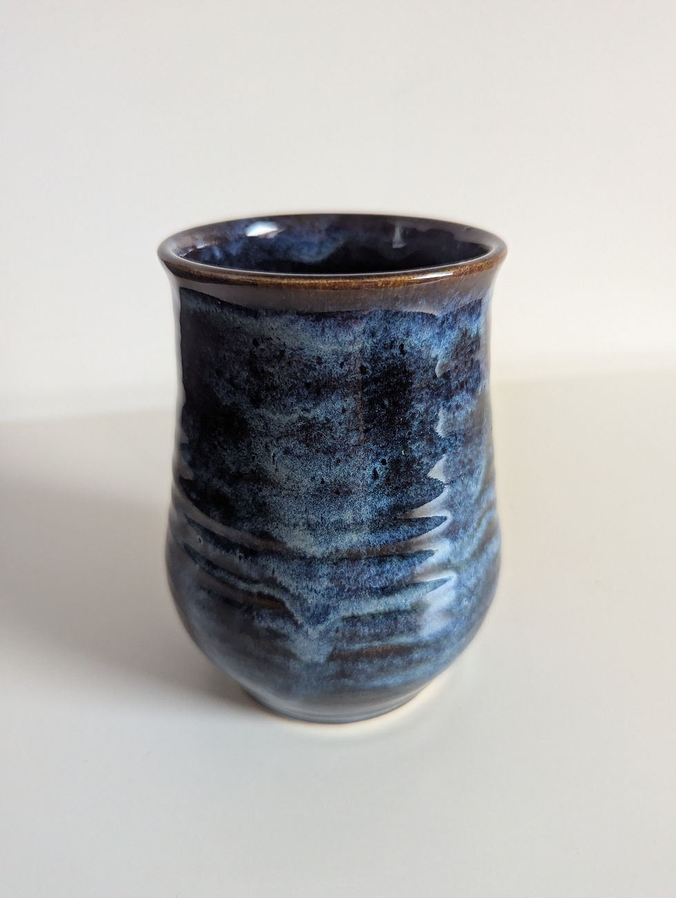 Thumbnail: Handmade stoneware vase in Stormy Blue glaze, showing its clean form and deep blue with warm brown glaze breaks.