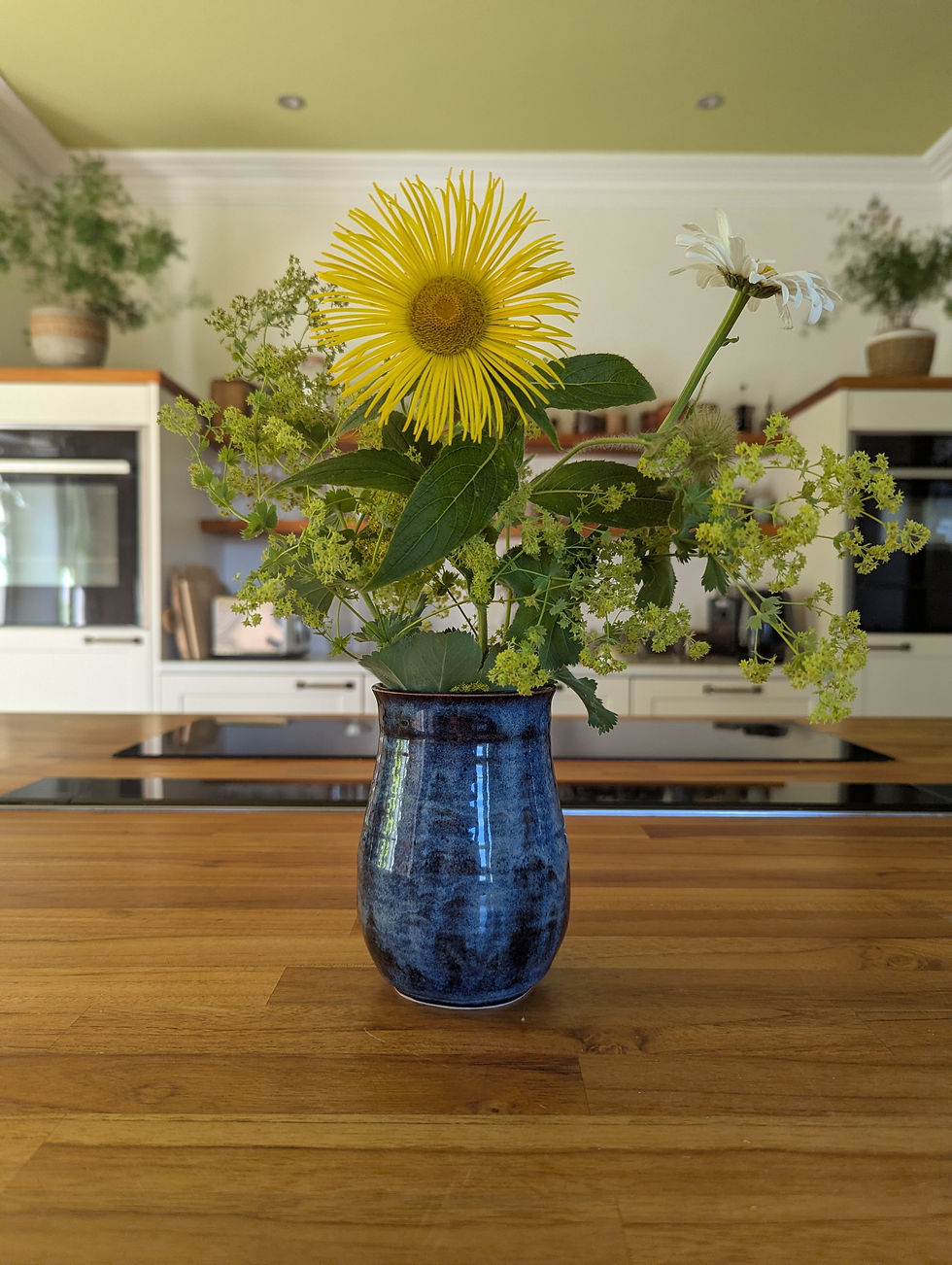 Handmade stoneware vase in Stormy Blue glaze with bunch of flowers
