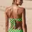 Thumbnail: Model wearing a Green Polka Dot bandeau bikini top with hipster bottom back view