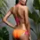 Thumbnail: Side profile of triangle bikini set in vibrant orange and pink colour block.