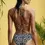 Thumbnail: Model wears Geometric Noir  Bandeau Bikini and High Leg Bikini Set
