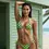 Thumbnail: model standing infornt of beach hut in a Green Polka Dot - String Tie Side Bikini Bottom and triangle bikini top