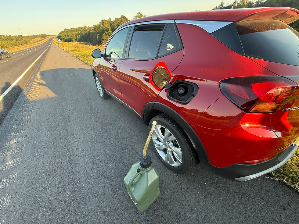 Red SUV needing emergency fuel delivery on the roadside.