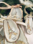 A set of eiffel tower oyster shell ornaments with wreaths on the tower.