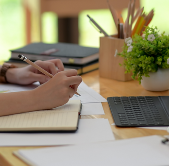 Person working with their notebook and laptop