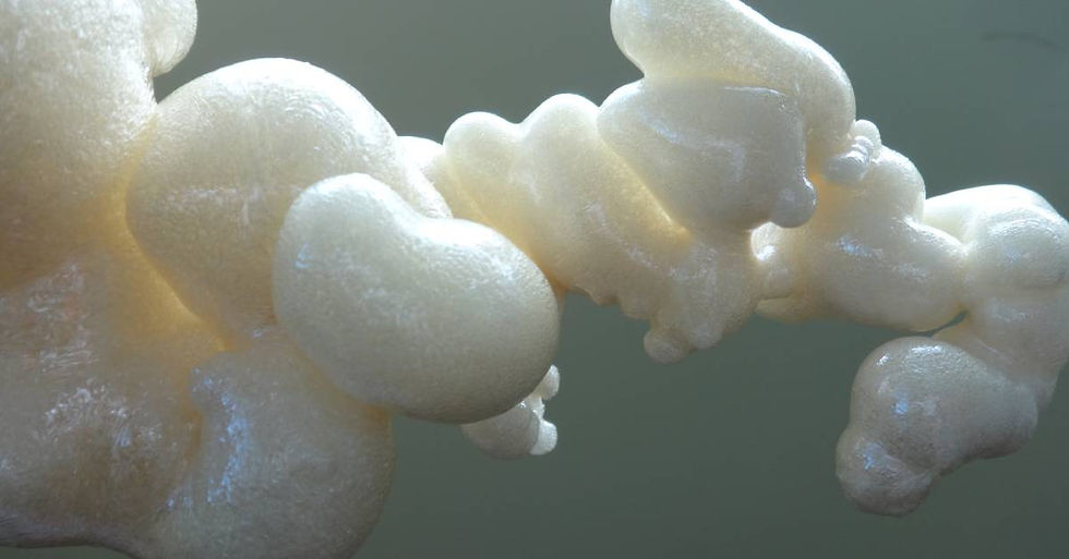 A close-up of polyurethane foam insulation with highlights on the surface over a shaded background.