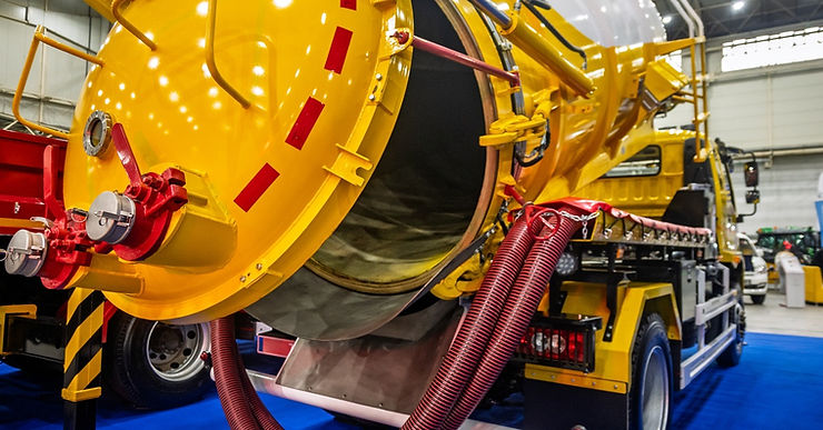 Image 2: A yellow truck is parked in an interior room. There are other trucks around it in the background.