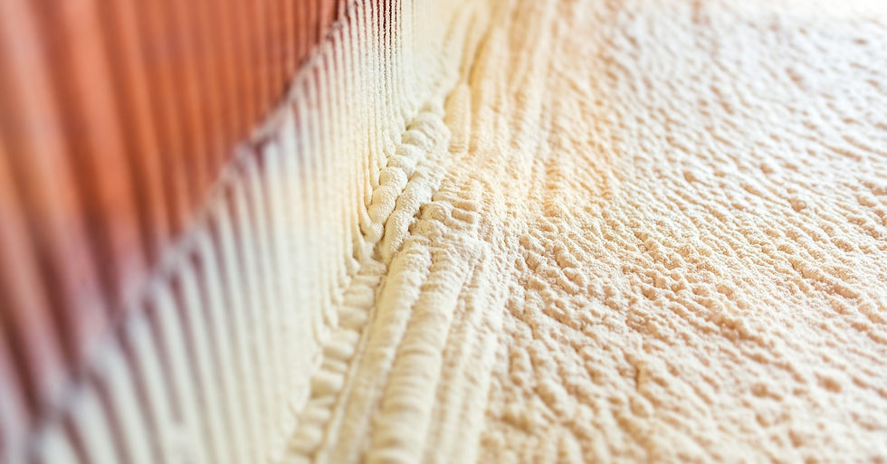 A light-colored foam is sprayed all over a surface. The foam has a bumpy texture to it and covers half the frame.