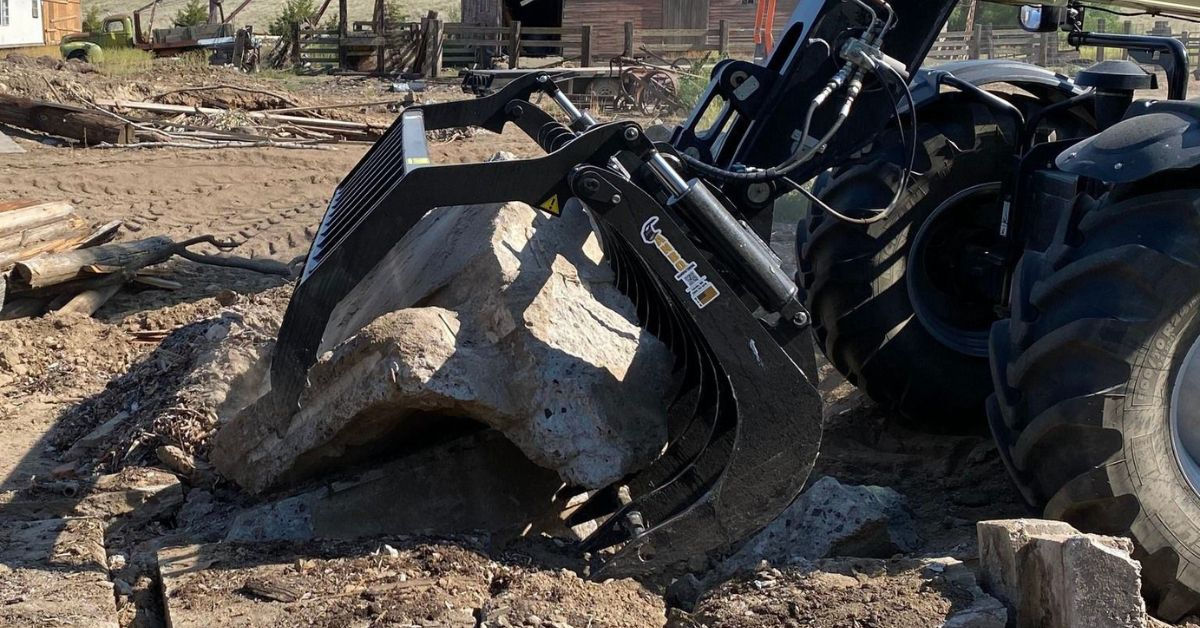 Compact tractor grapple handling yard debris
