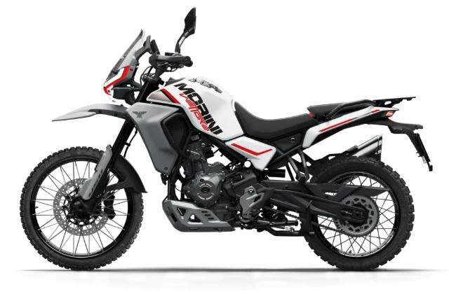 The left side of a white motorcycle with all-terrain tires, a small windshield, and the words “Morini Vettore”.
