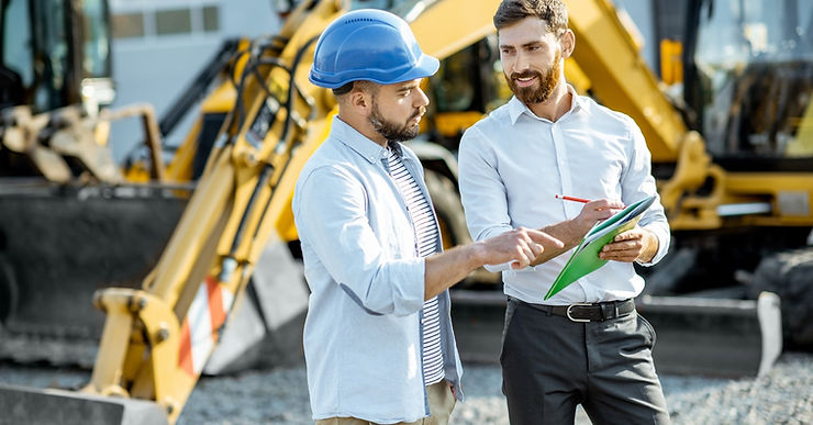 Image 3: Two men are standing next to each other in a construction zone. One is wearing hard hat and the other is not.