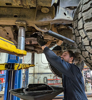 A technician doing an oil change.