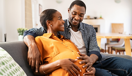 Black mother sitting on the couch with her partner