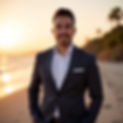 Omer El Salhani, Southern California real estate consultant, standing on a beach at sunset in Orange County