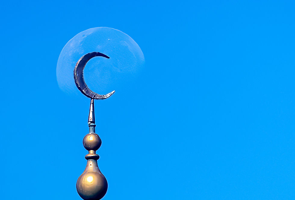 Golden crescent with the moon in a clear blue sky, creating a tranquil and serene atmosphere.