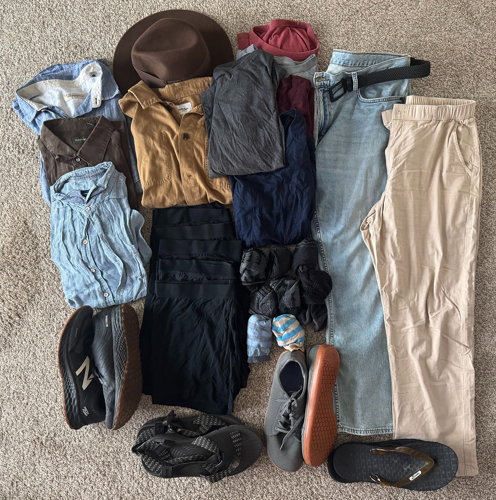 Clothing and shoes neatly arranged on a beige carpet, featuring shirts, pants, hats, and footwear in various earthy tones.