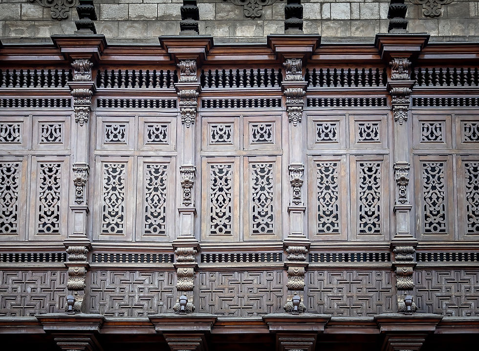 Ornate wooden facade with intricate carvings and decorative columns. Warm tones, creating a historic and artistic atmosphere.