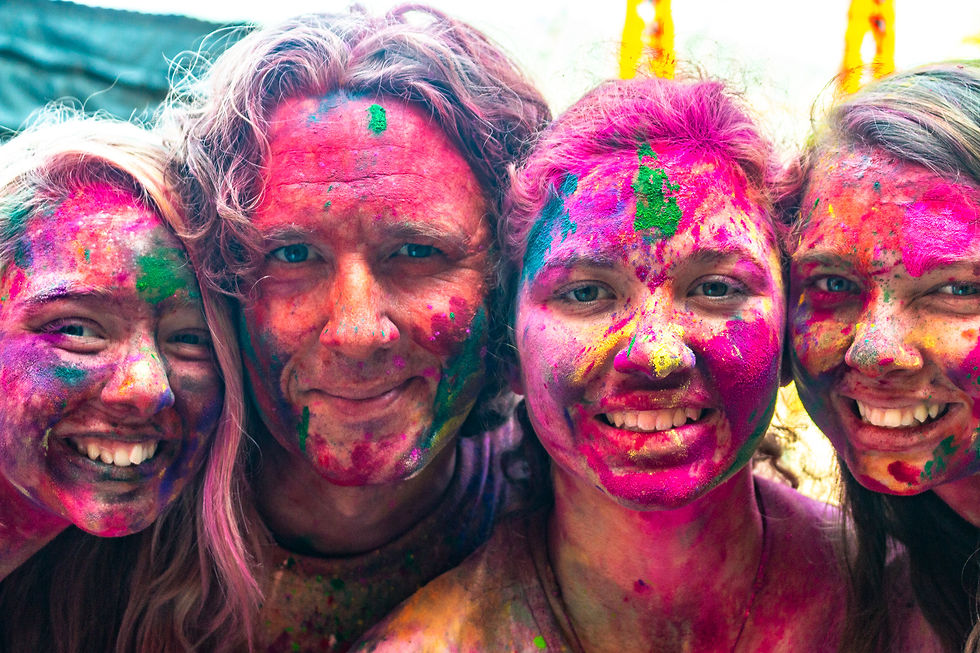 A man and his three daughters with painted faces at Holi in India
