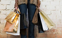 woman-holding-shopping-bags-near-wall_23