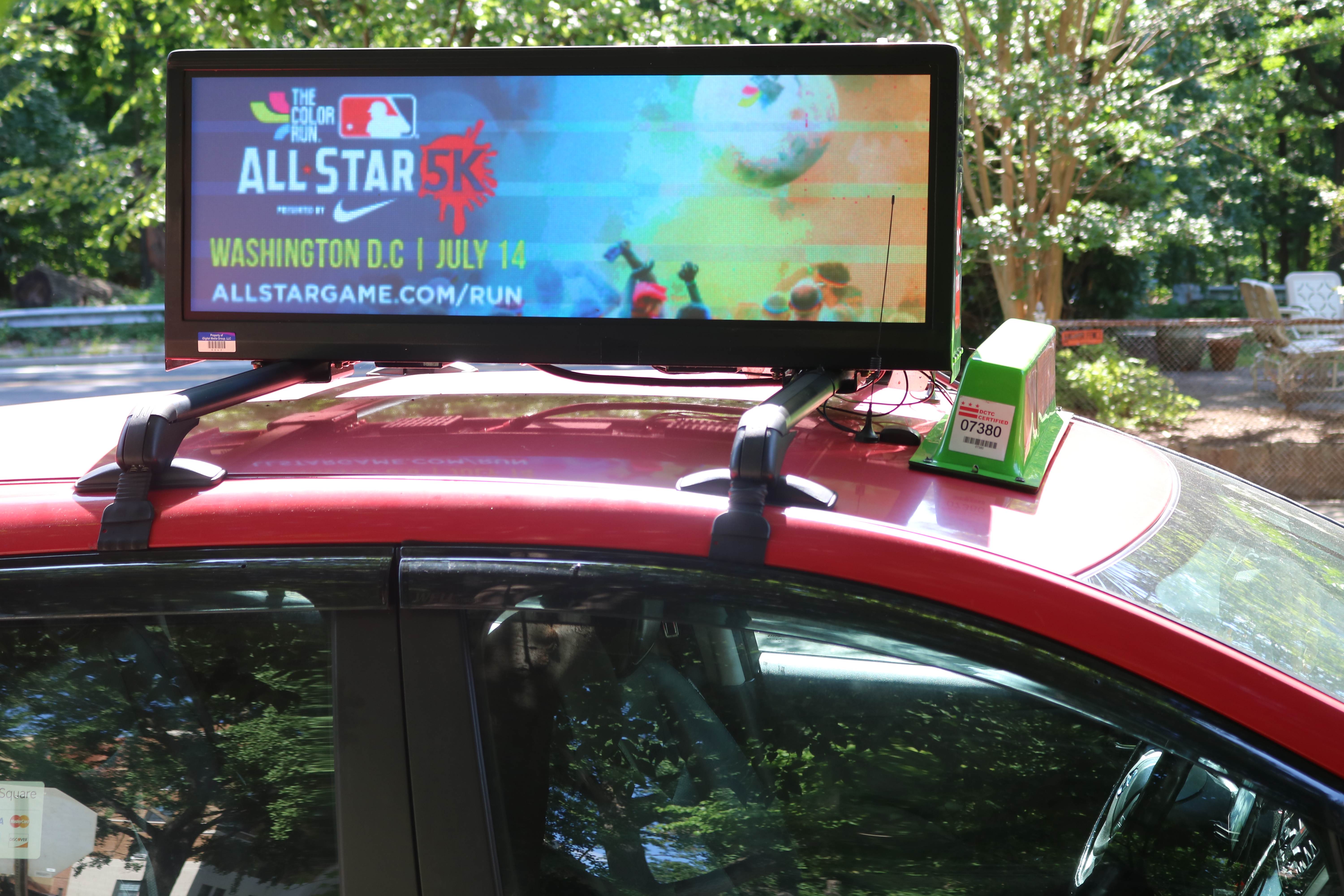 Taxi with a digital rooftop ad for the MLB All-Star 5K in Washington, DC