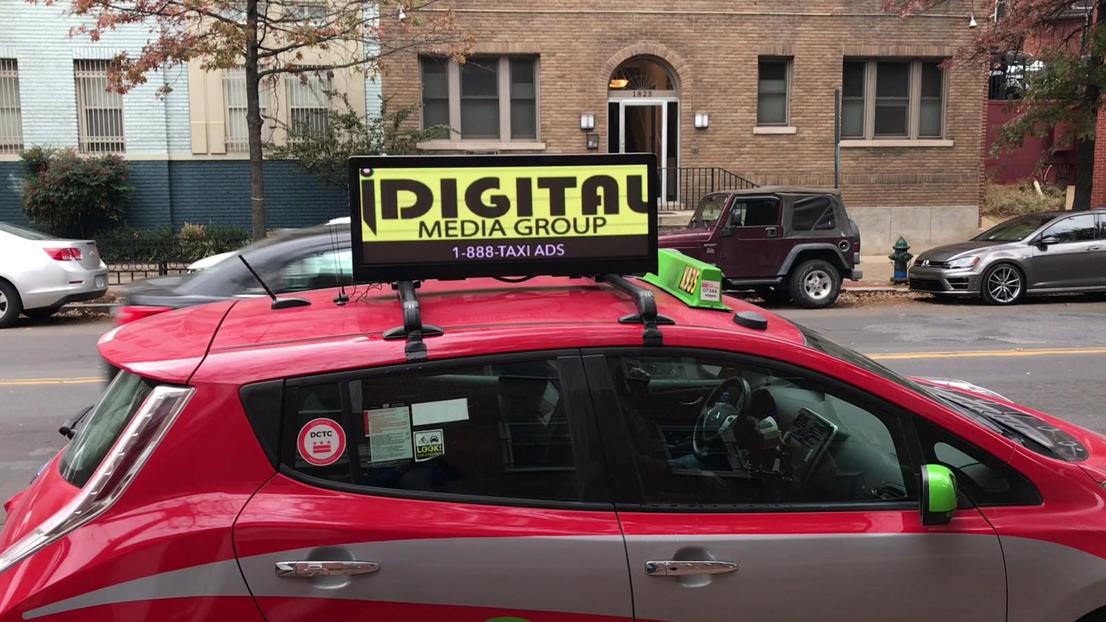 Car with an iDigital Media Group digital rooftop display