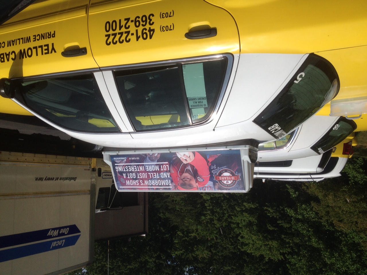 Yellow taxi with a digital rooftop ad