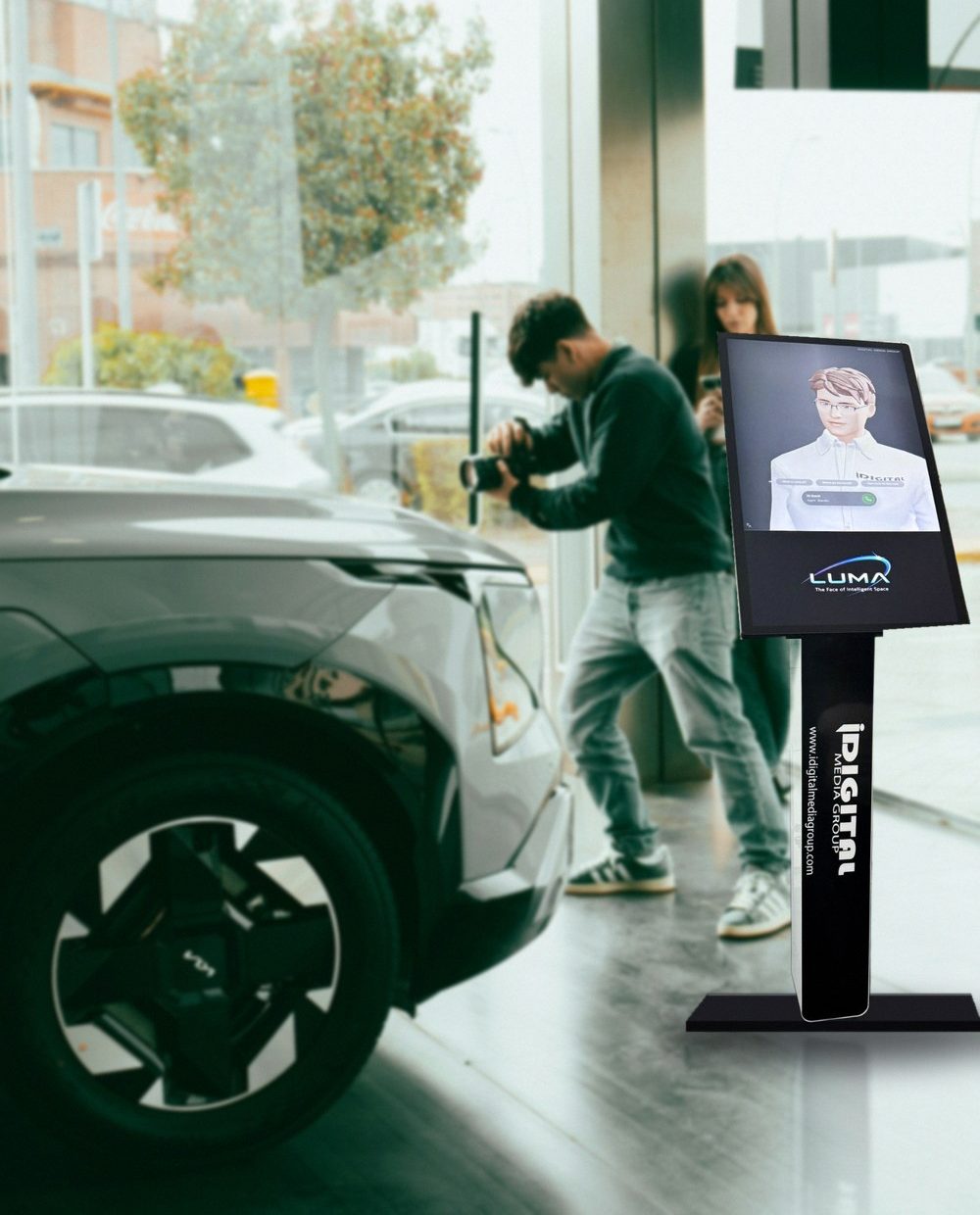 Luma AI concierge kiosk on a car dealership showroom floor with customers nearby