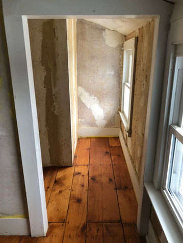 Hallway needing drywall repair and painting