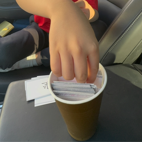 Child grabbing cards in Boom game.