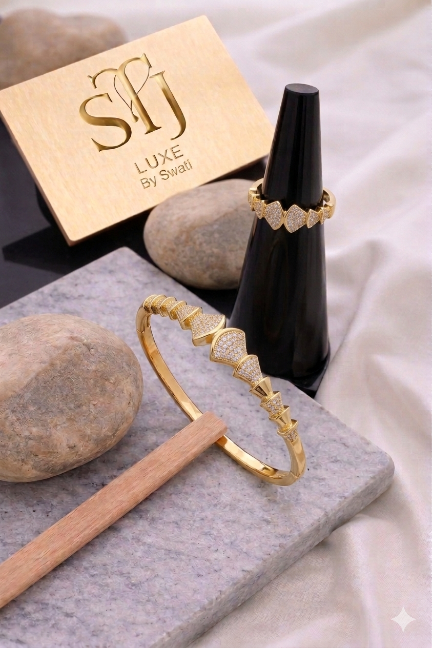 Gold bracelet and ring with white triangular accents; SJ LUXE card