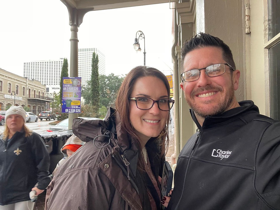 two people standing on the sidewalk