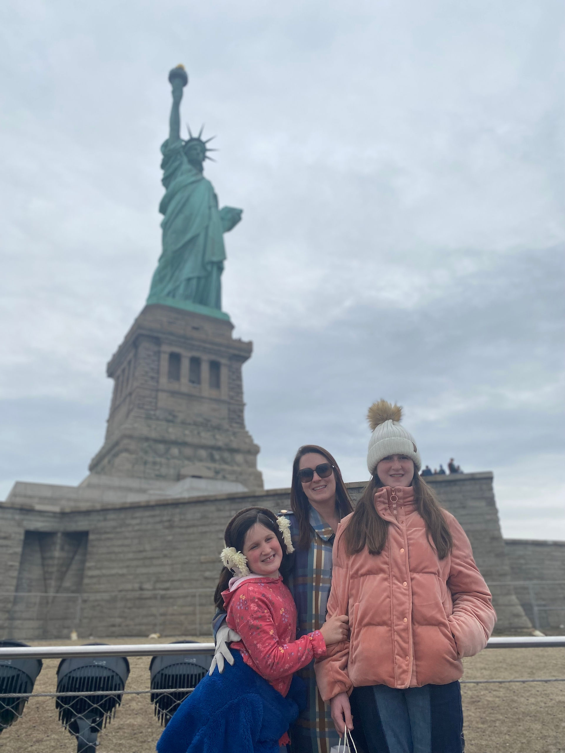 Me and my girls in front of the Statute of Liberty