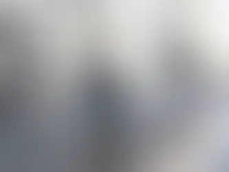 Homem de mochila a pedalar numa bicicleta partilhada numa ciclovia marcada no asfalto, numa rua do centro histórico com prédios antigos e peões ao fundo – ciclovias lisboa.