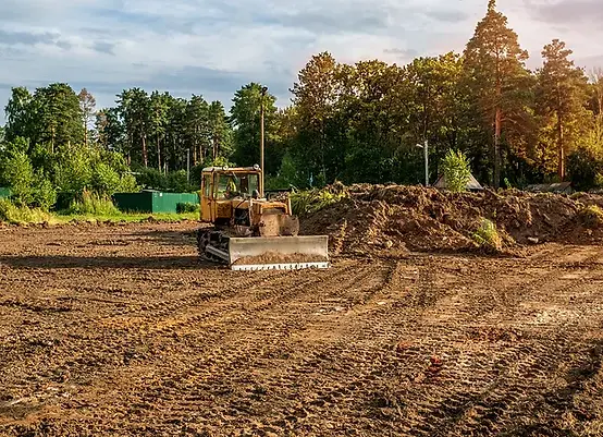 The excavator cleared the land leaving traces _ Selective focus_ Copy space_ A horizontal