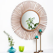 Golden sunburst mirror reflects green leaves. Blue and green vases with plants, and teal candle holders, against a white background. ecommerce photoshoot, product photography near me, amazon photoshoot, product photography in delhi, ecommerce photography delhi