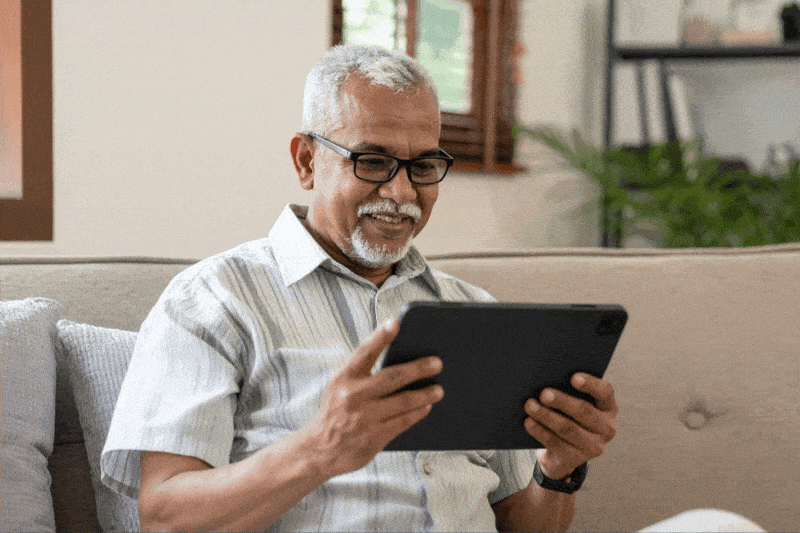 A man looking at a tablet during a telehealth appointment