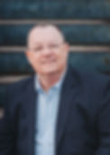 John Bentley Headshot on Steps Dark Blue Suit.jpg