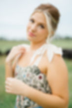 Molly Clair in a white blouse looking into camera for portrait shot