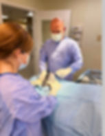 Veterinarians performing surgery on a pet