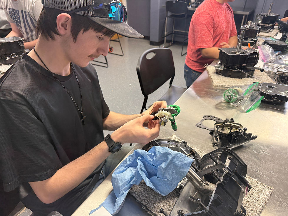 Student assembling a mechanical part for a classroom grant.