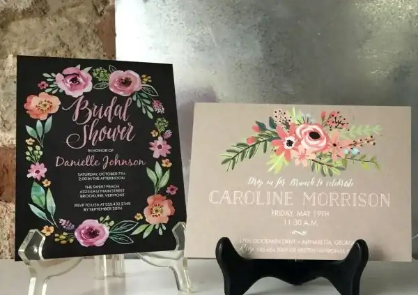 Floral bridal shower invitations on a display stand