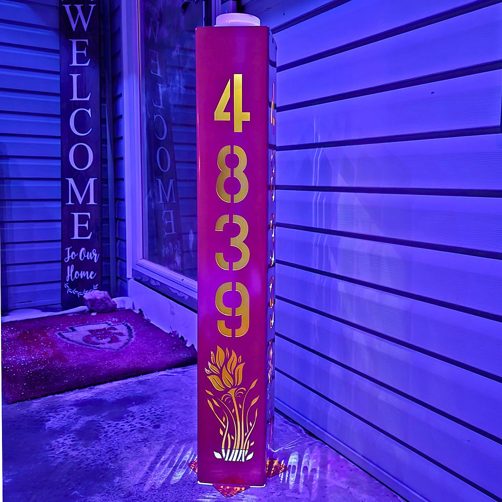 Illuminated steel address post with floral design, precision-cut for modern outdoor decor.
