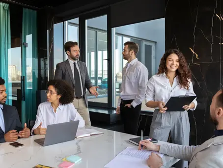 A professional team collaborating in a modern office, showcasing how Confetti Recruitment helps businesses beat the hiring crisis by finding the right offshore staffing solutions.