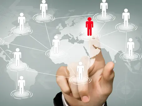 A hand interacting with a digital world map featuring connected human icons, highlighting a red figure to represent offshore staffing. This visual illustrates how to build your global team through Confetti Recruitment’s specialized offshore hiring solutions.