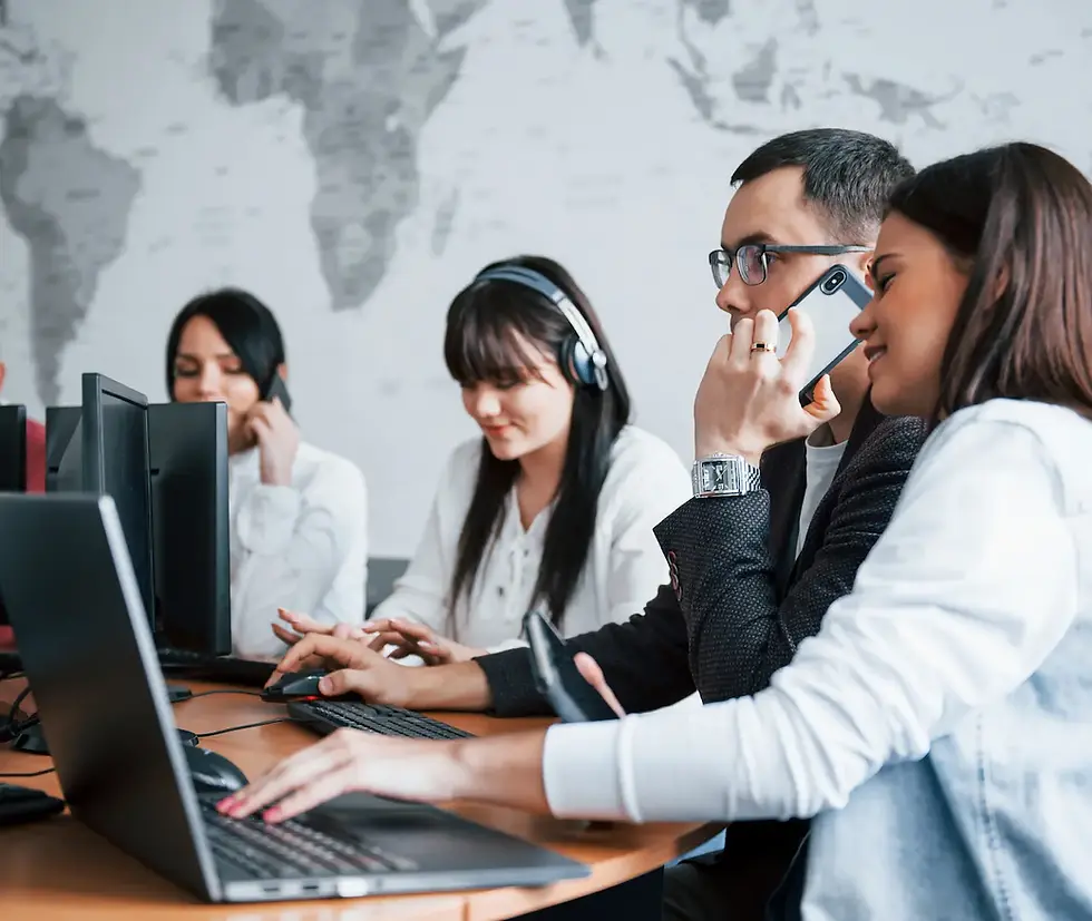 A group of diverse professionals working together in an outsourced call center, illustrating how Confetti Recruitment provides sales outsourcing solutions to help businesses expand their reach and dominate their market.