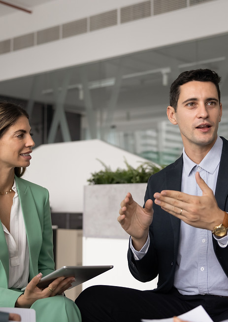 Teammates listen colleague explain point of view, idea or opinion, seated in modern office