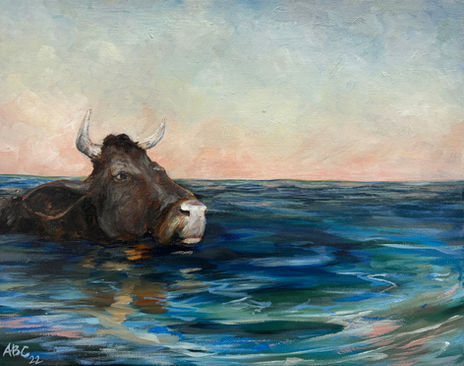 sunrise over water with dark water buffalo swimming through