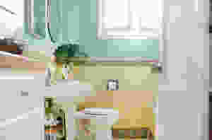 An open door reveals a small yellow bathroom. This photo is part of a blog for eConserve, a multifamily water company.