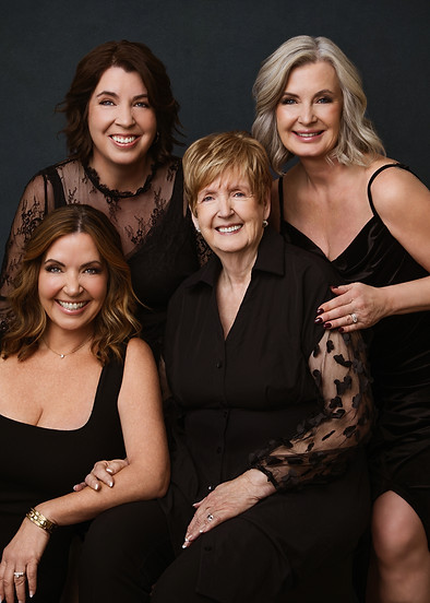 Mother and her daughters in black dresses, multi-generational portrait